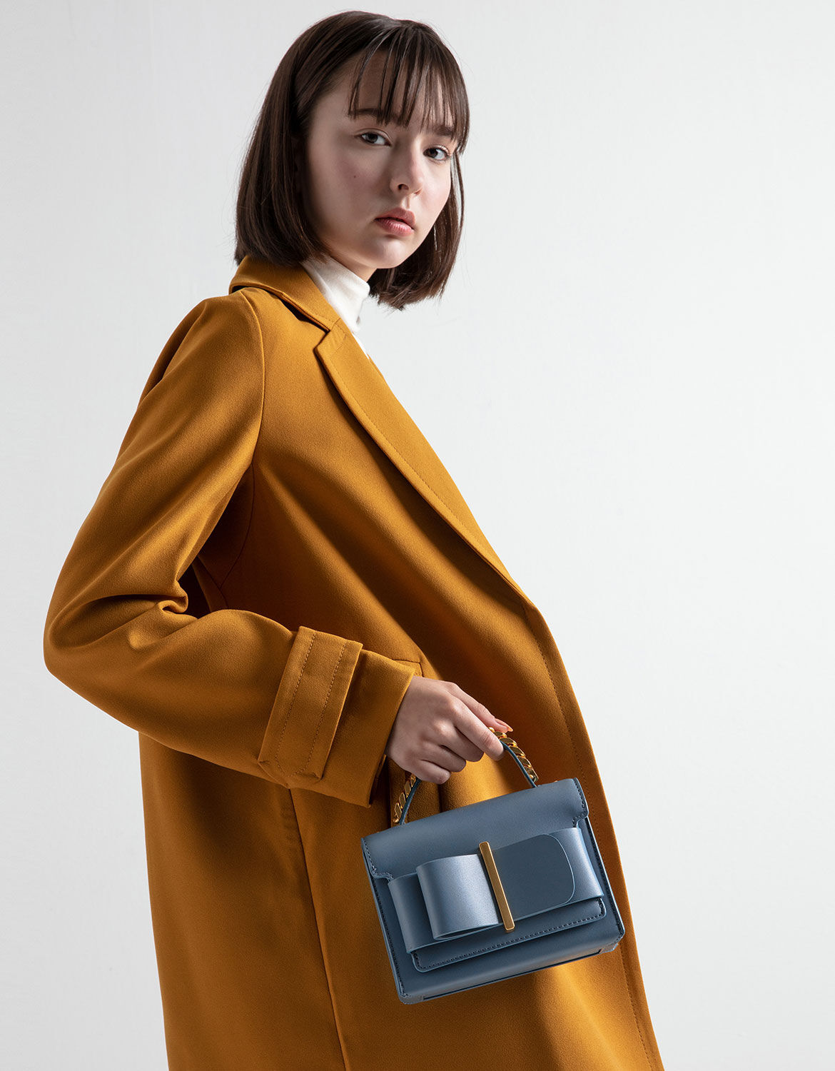 charles & keith chunky metal top handle bow flap bag