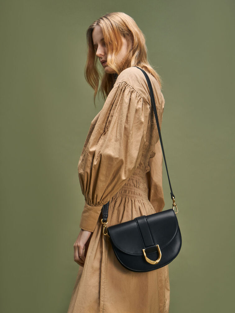 Available in three versatile neutral shades — black, brown and chalk — the  Gabine leather saddle bag is a true modern classic that is…