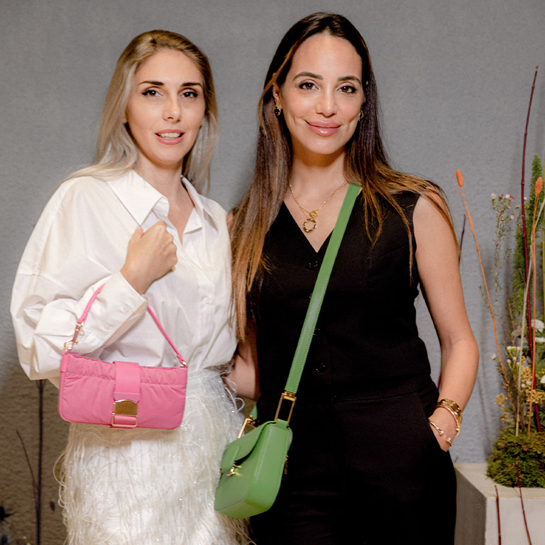 Women’s Koa square push-lock shoulder bag in green and Aspen ruched phone pouch in pink, as seen on Zeynab El-Helw and Emina - CHARLES & KEITH