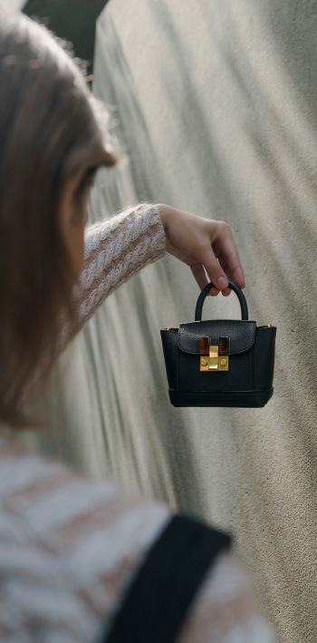 Women’s stone-embellished pouch bag in black – CHARLES & KEITH