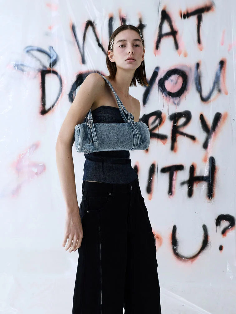 The Rey elongated shoulder bag in denim styled with an off-duty outfit.