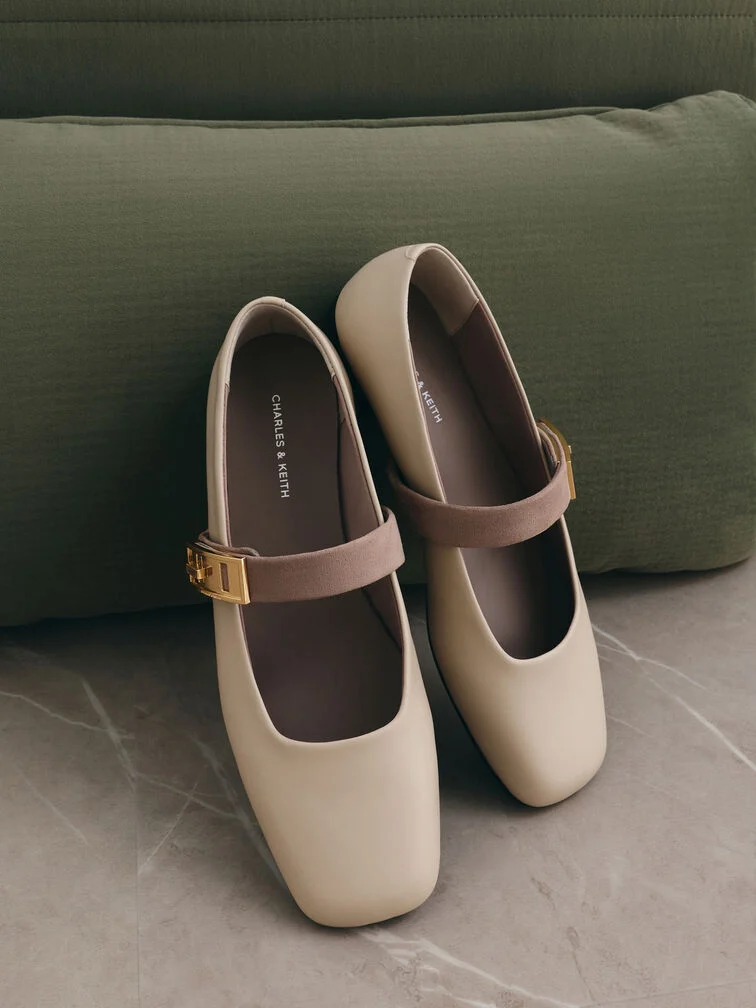 Classic Mary Jane flats with buckled straps fastened across the insteps. 