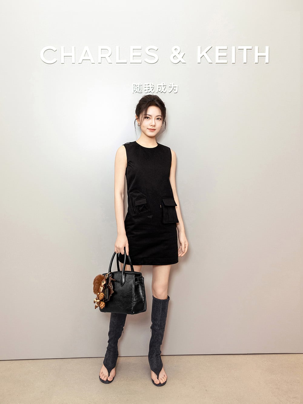 CHARLES & KEITH brand ambassador Zhao Jinmai wearing the Aether thong boots and carrying the Ginevra tote bag - CHARLES & KEITH