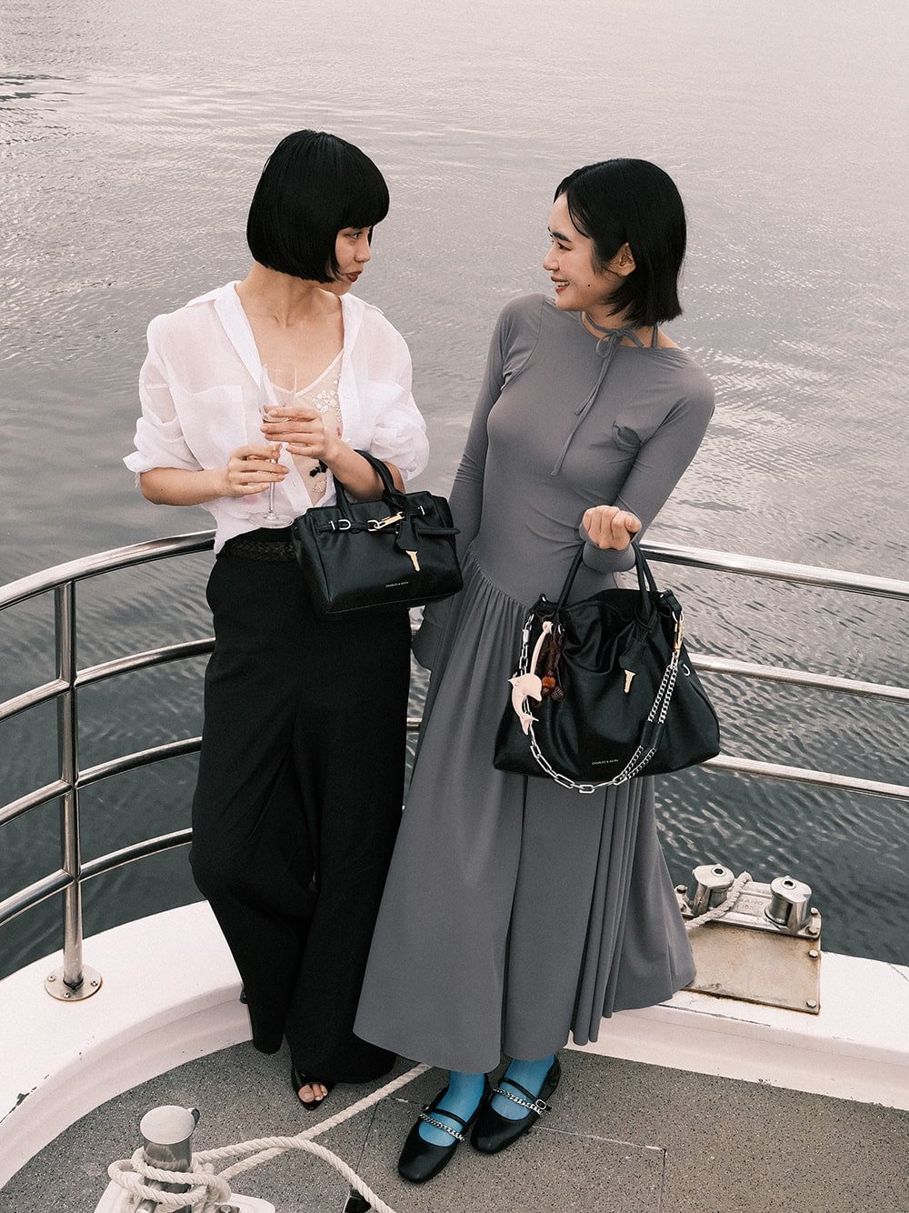 Women’s Delfina chain tote bag, Delfina belted tote bag and Delfina dolphin chamr, as seen on Ruka Xing and Yur Okamoto - CHARLES & KEITH