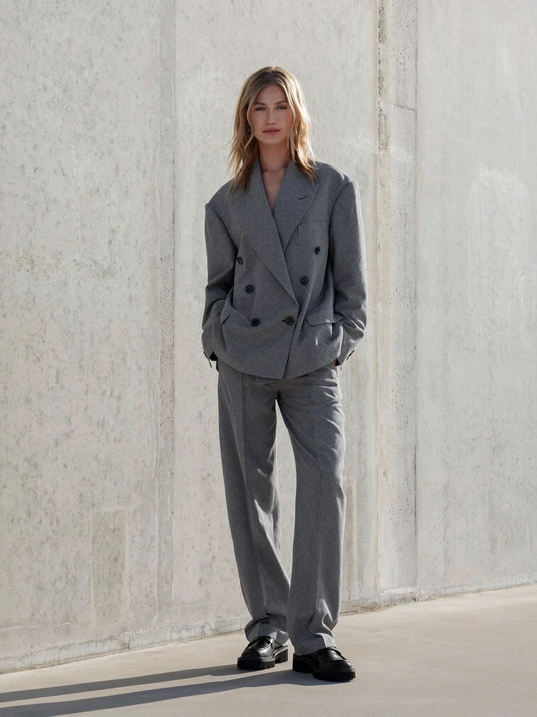 Loafers styled with a grey blazer and tailored trousers for a work-ready outfit