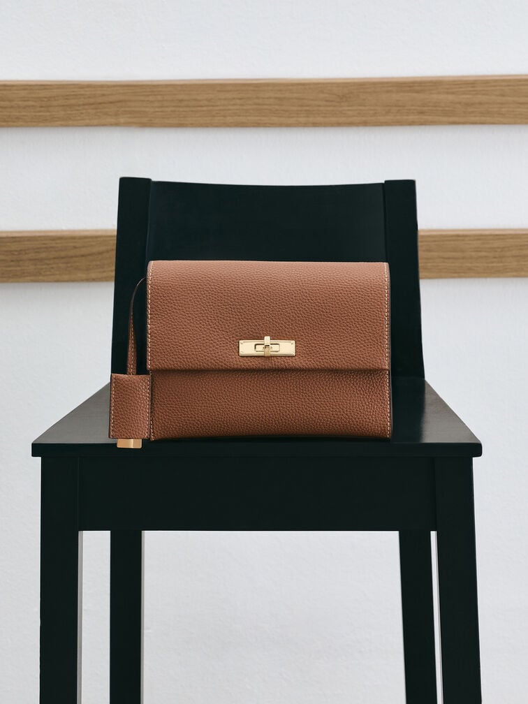 A classic flap-style bag featuring a front-flap design and turn-lock closure