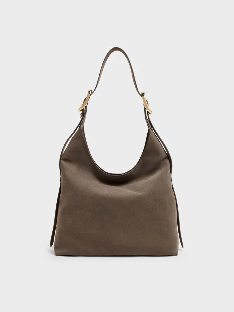 El bolso hobo Aislin en gris piedra presenta una silueta espaciosa ideal para llevar los imprescindibles del día a día.