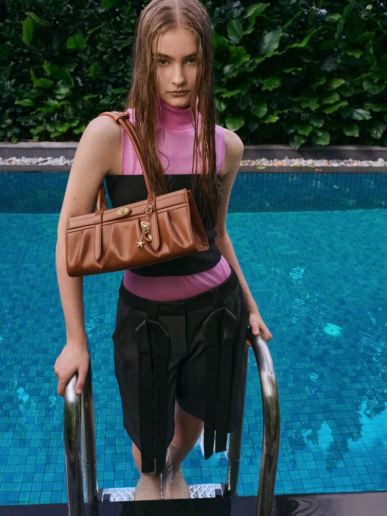 The Isolde belted shoulder bag styled with a summer outfit.