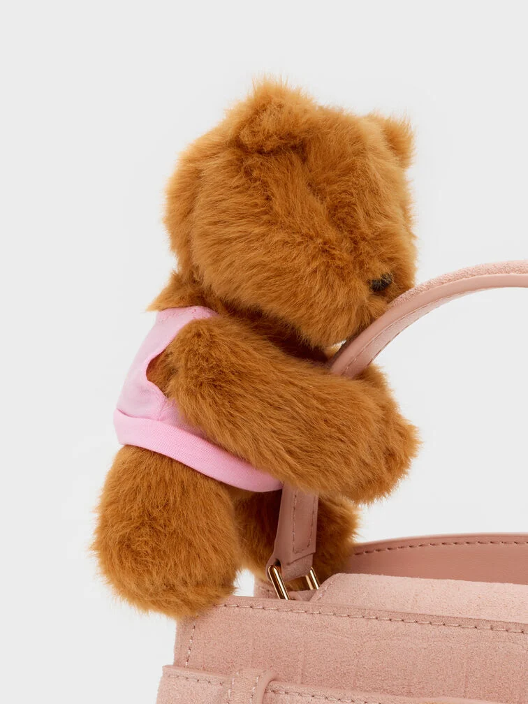  A plush bear charm on a pink bag for an ultra-cute finish