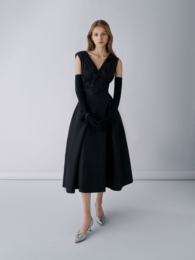 Glittered pointed-toe pumps paired with a formal black dress