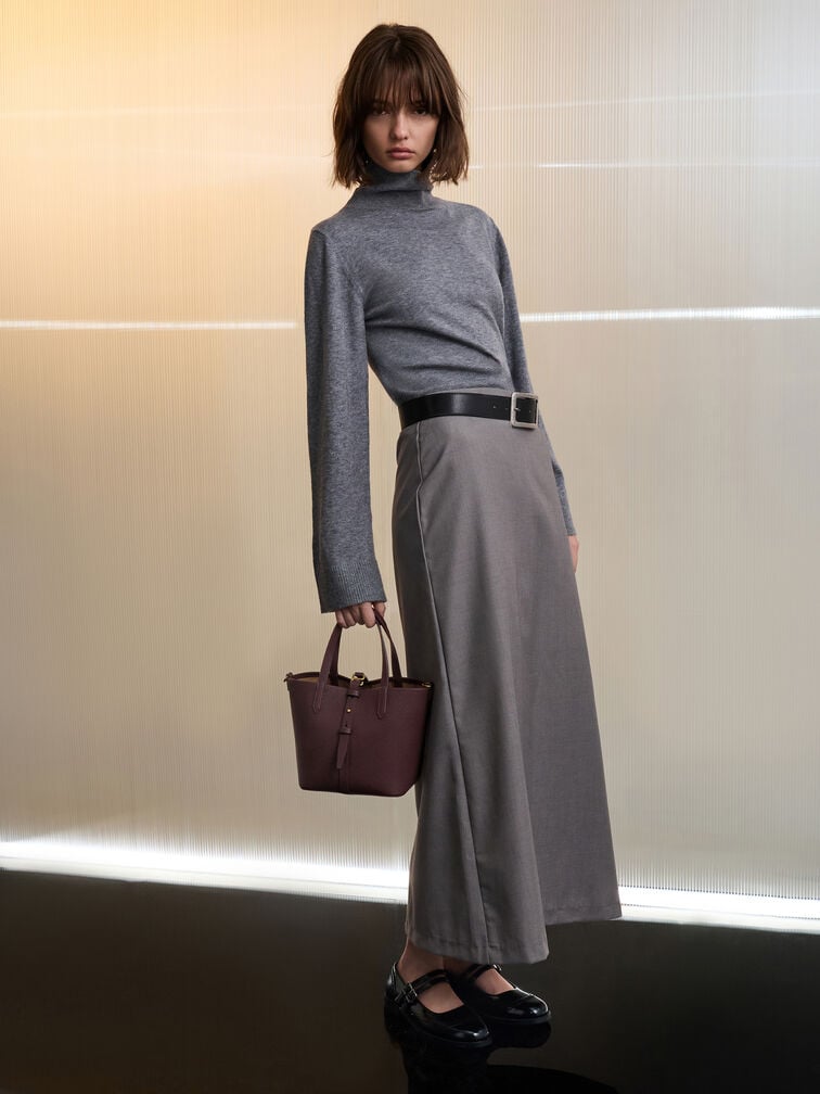 Wineberry red belted bucket bag styled with a slim turtleneck jumper, long skirt and Mary Janes.