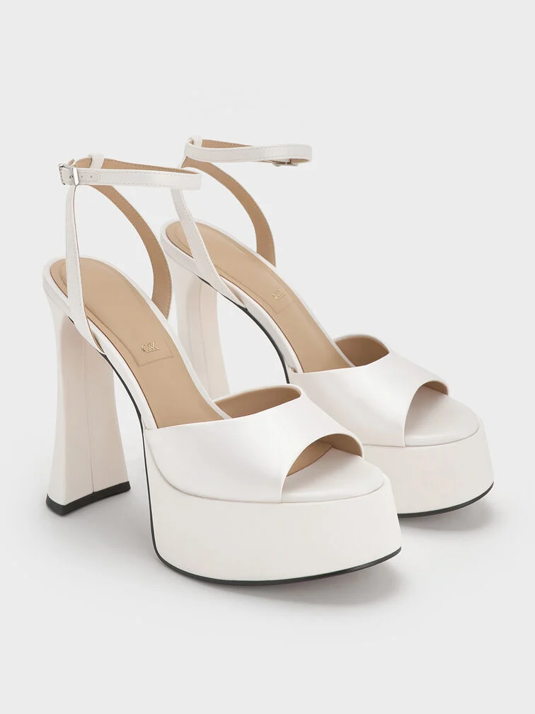 Platform sandals maximize the leg-lengthening effect of a short dress.