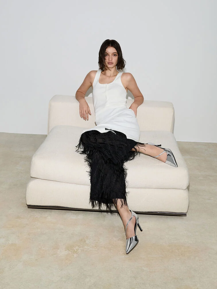 Metallic silver d’Orsay stiletto pumps, the perfect finishing touch to a dressy white tank top and feather skirt ensemble.