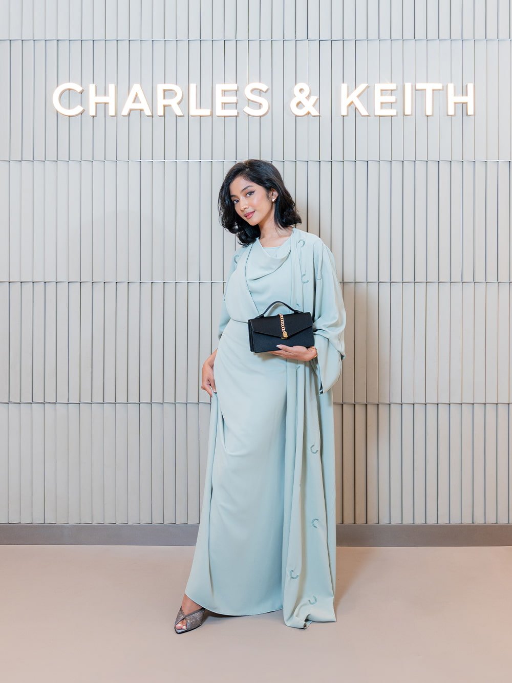 Taisia Satin Chain-Strap Envelope Bag in black textured; Glittered Mesh Peep-Toe Heeled Mules in grey - CHARLES & KEITH