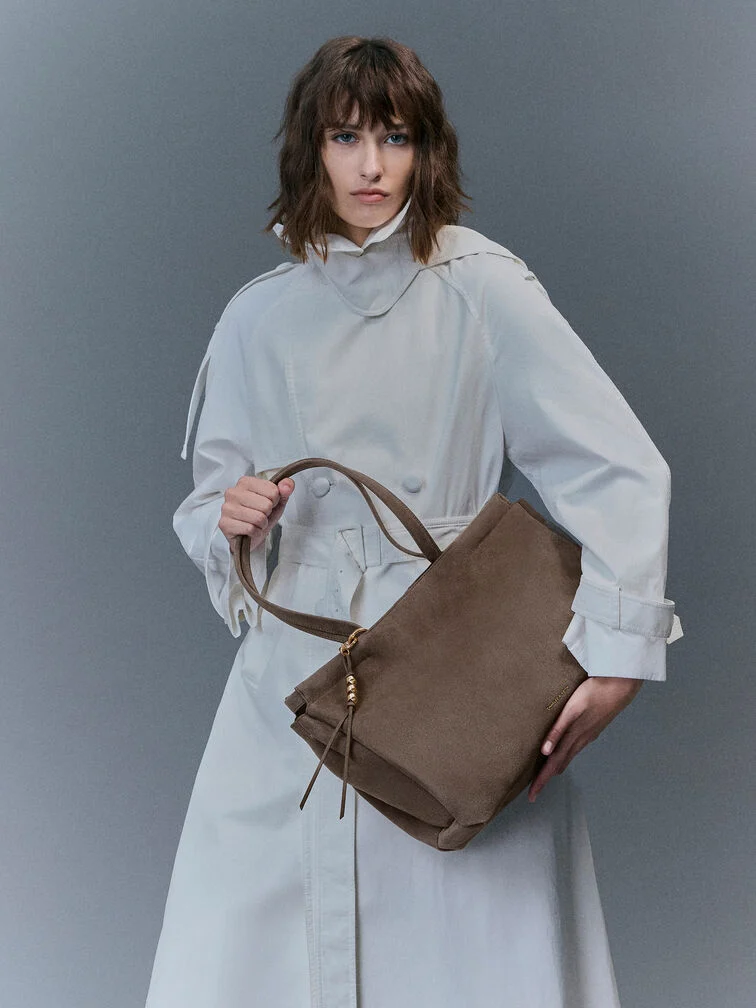 The suede Zephyr tote bag is a classic choice for the office.