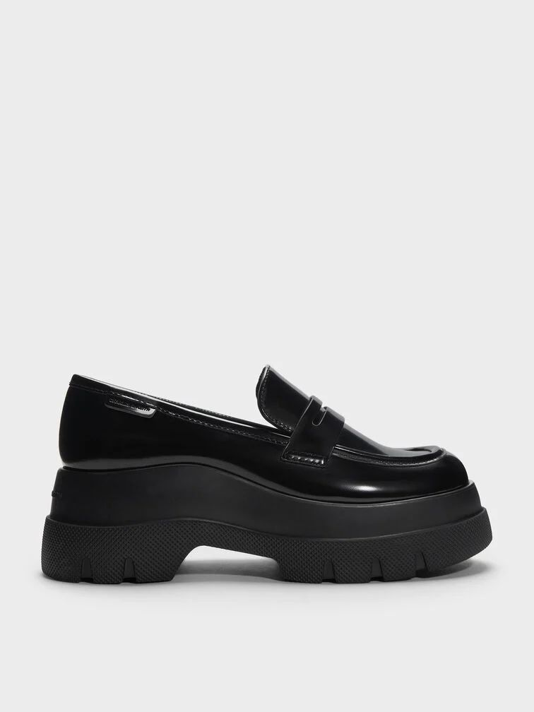 Black penny loafers set atop thick platform soles