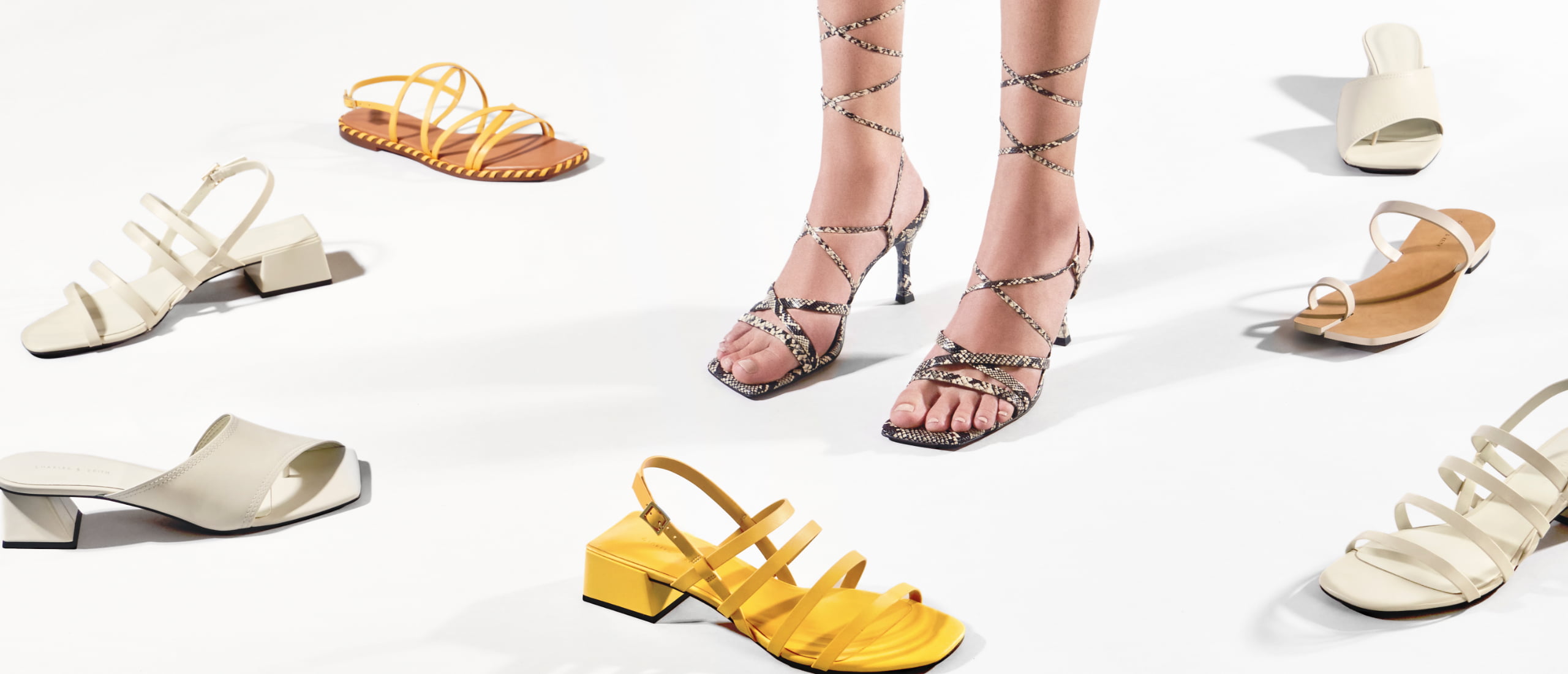 Women’s whipstitch trim strappy sandals, snake print tie-around strappy sandals, trapeze heel asymmetric heels, strappy geometric slingback sandals and toe ring flat sandals - CHARLES & KEITH