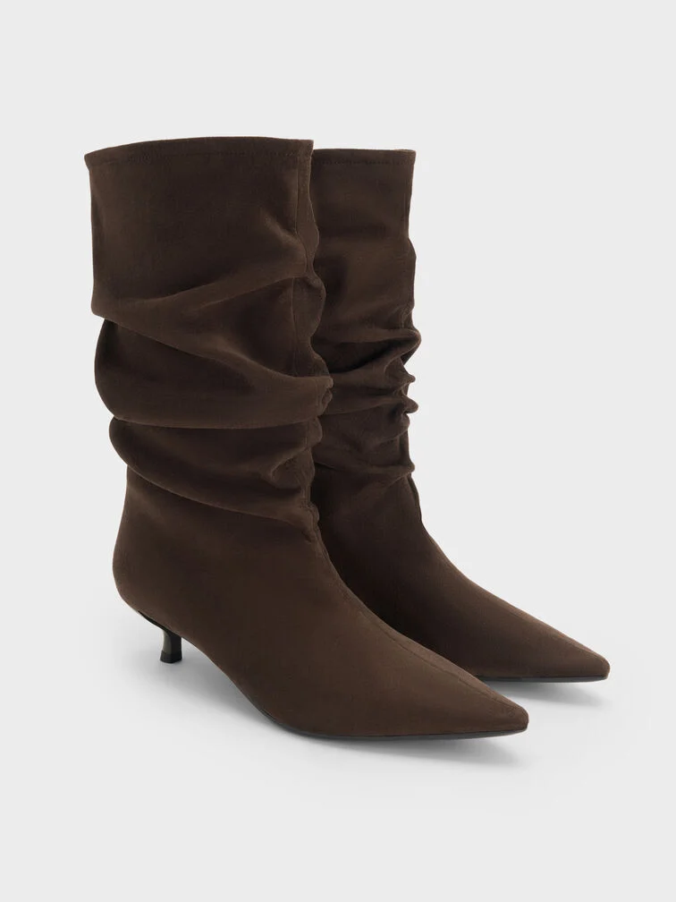 Typically made of soft leather or suede, the flexible construction of slouchy boots gives them their signature ruched shafts. 