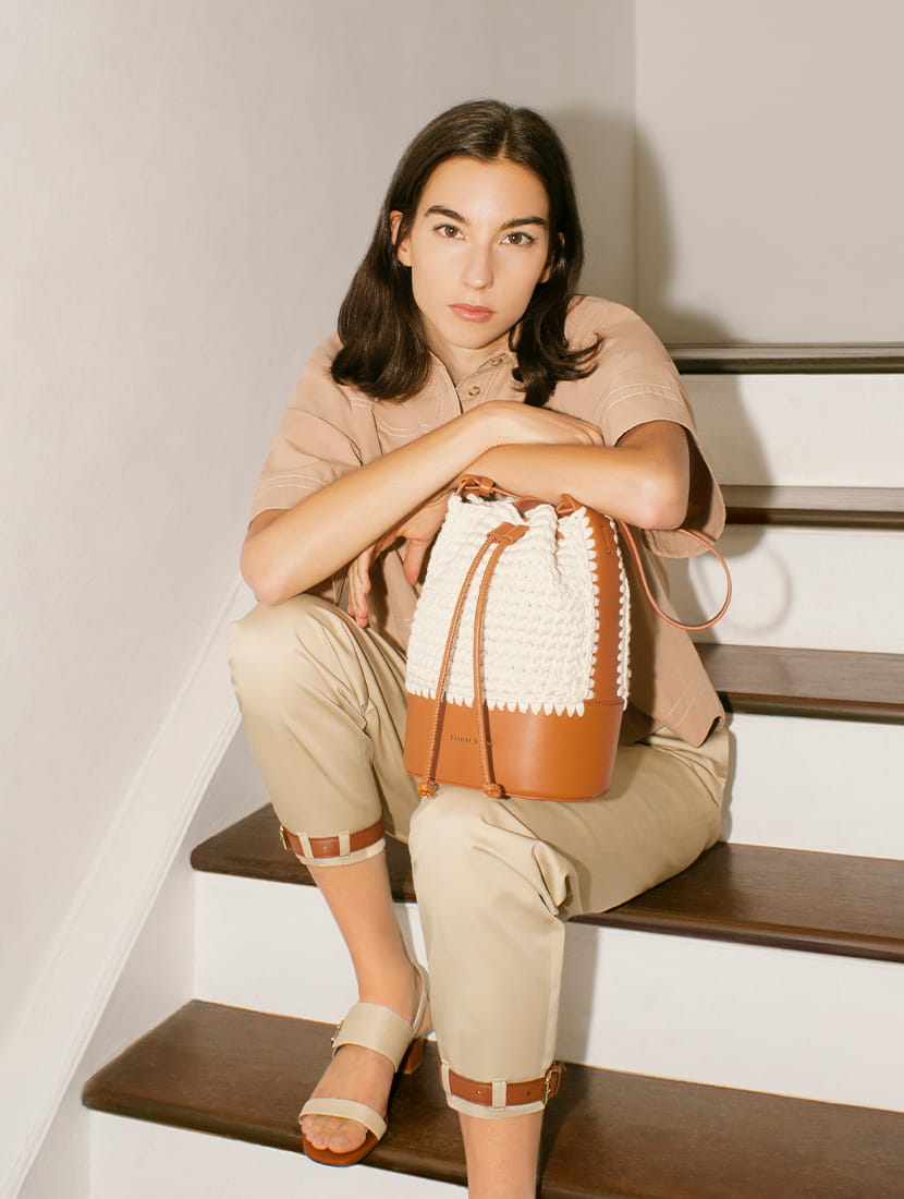 Women’s crochet drawstring bucket bag and raffia buckle strap sandals in sand - CHARLES & KEITH