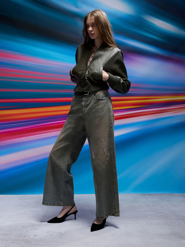 Black wide-leg jeans styled with black pointed-toe pumps to create a continuous silhouette that elongates the toe line.