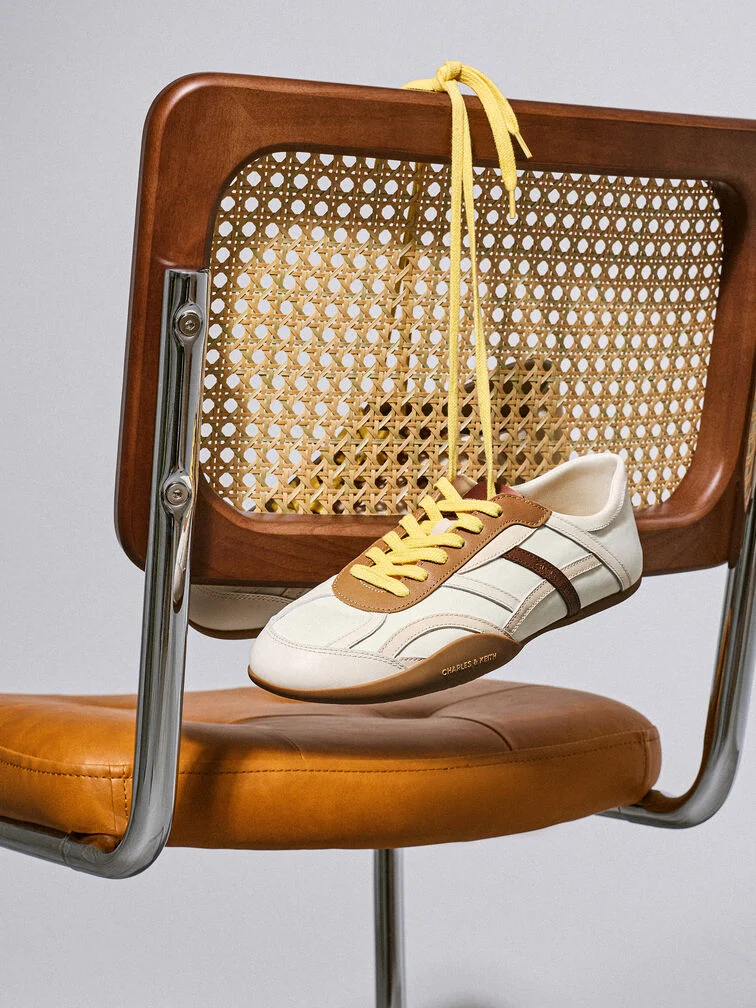 Clean-lined low-profile sneakers would balance out the distinctive volume of wide leg pants to create a cool and youthful look.