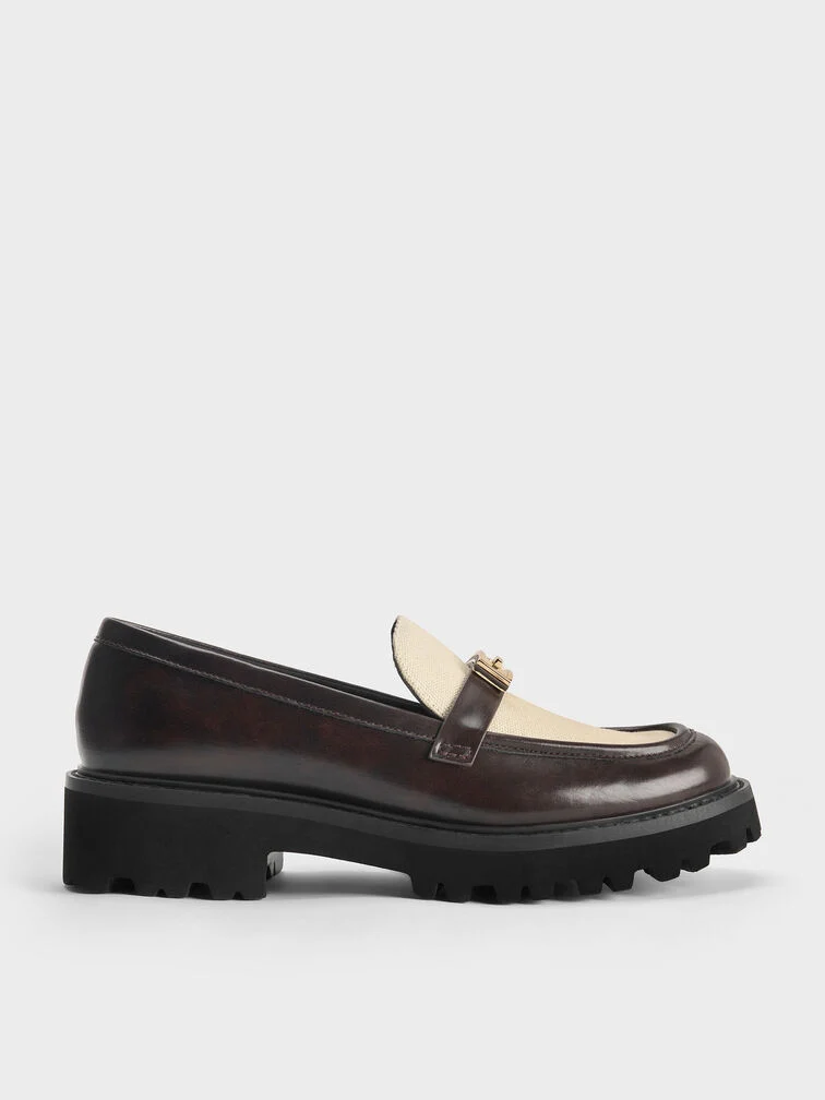 Lug-sole loafers are identifiable by their rubber soles with ridged indentations.