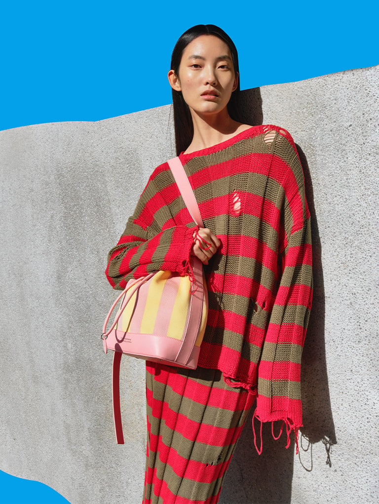 Women’s striped bucket bag from the Short Sentence x CHARLES & KEITH collection on model - CHARLES & KEITH