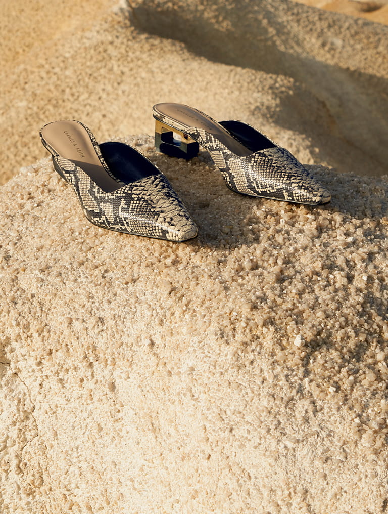Women’s snakeskin print sculptural chrome heel mules