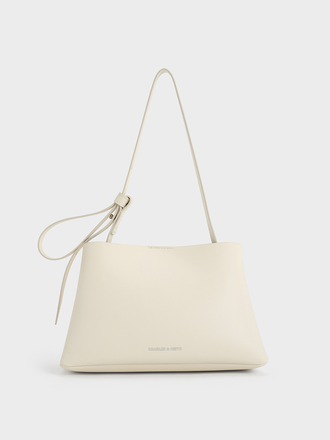 Shop Charles & Keith Odella Trapeze Bucket Bag In Cream